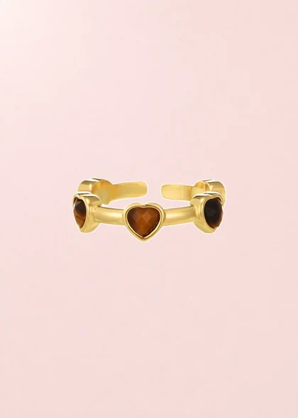 Mika Heart ring with three heart details, shown on its composite pink background