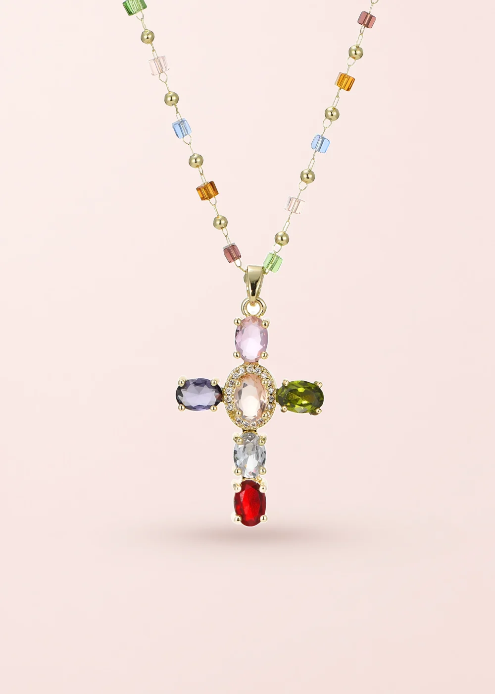 Geraldine Colorful Crystal Cross Golden Necklace on a pink background