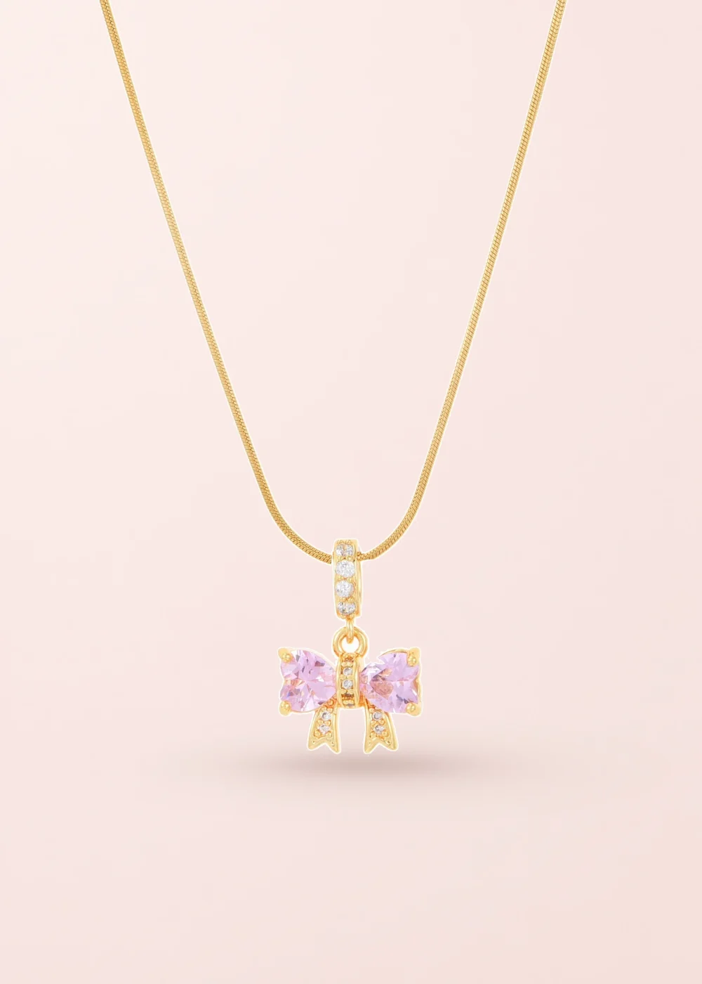 Produktfoto: Marvis Pink Bow – Halskette mit rosa Schleifenmotiv in Goldoptik