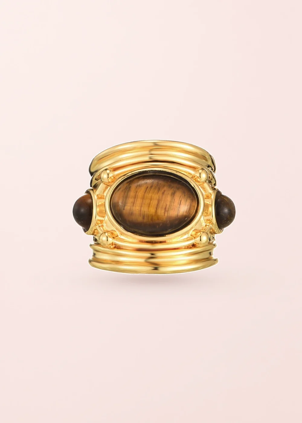 Brynne Golden Chunky Ring on a pink background