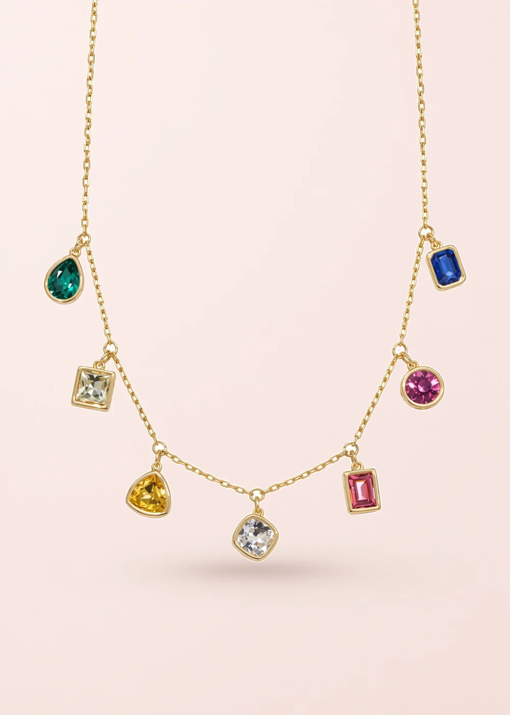 Dalia Colorful Crystals Golden Necklace on a pink background
